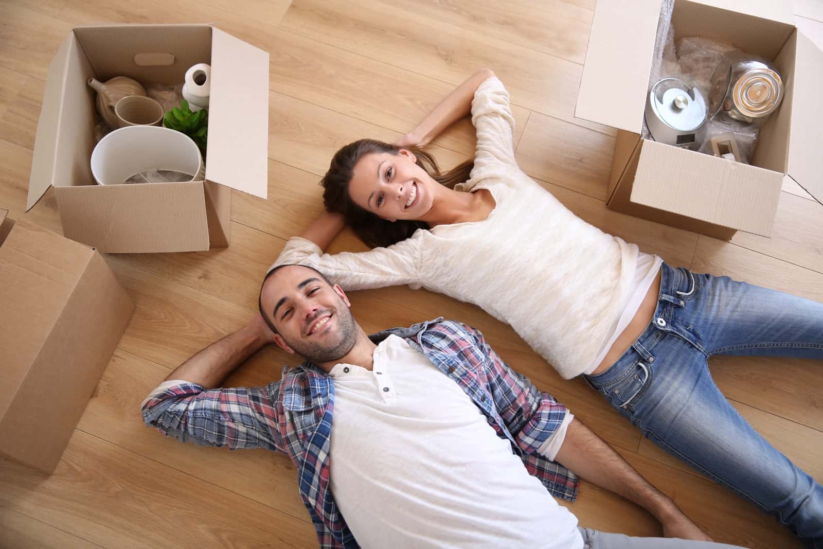 Young adults moving in new rented apartment