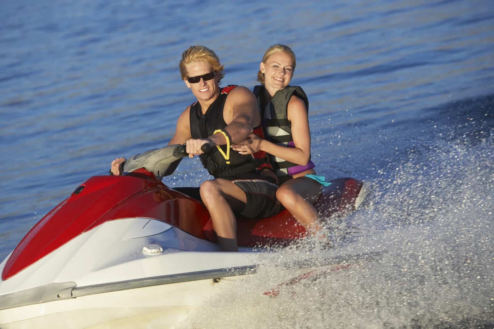 Happy couple riding jetski on Tampa Bay